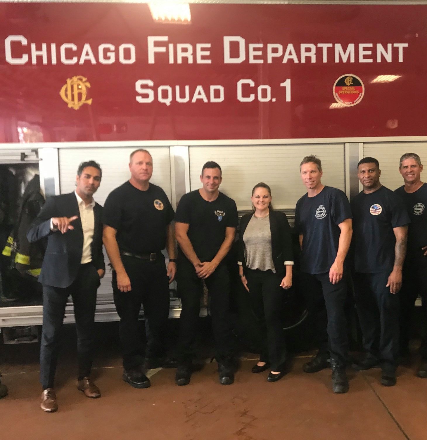 picture of Truluck's team members posing with local Chicago Fire Department firefighters