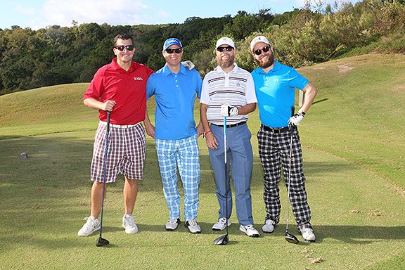picture of Four men posing with golf clubs wearing ugly golf pants