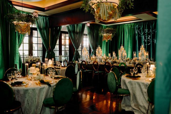 Woodlands stone crab room with emerald green drapery, and table cloths and crystal decor