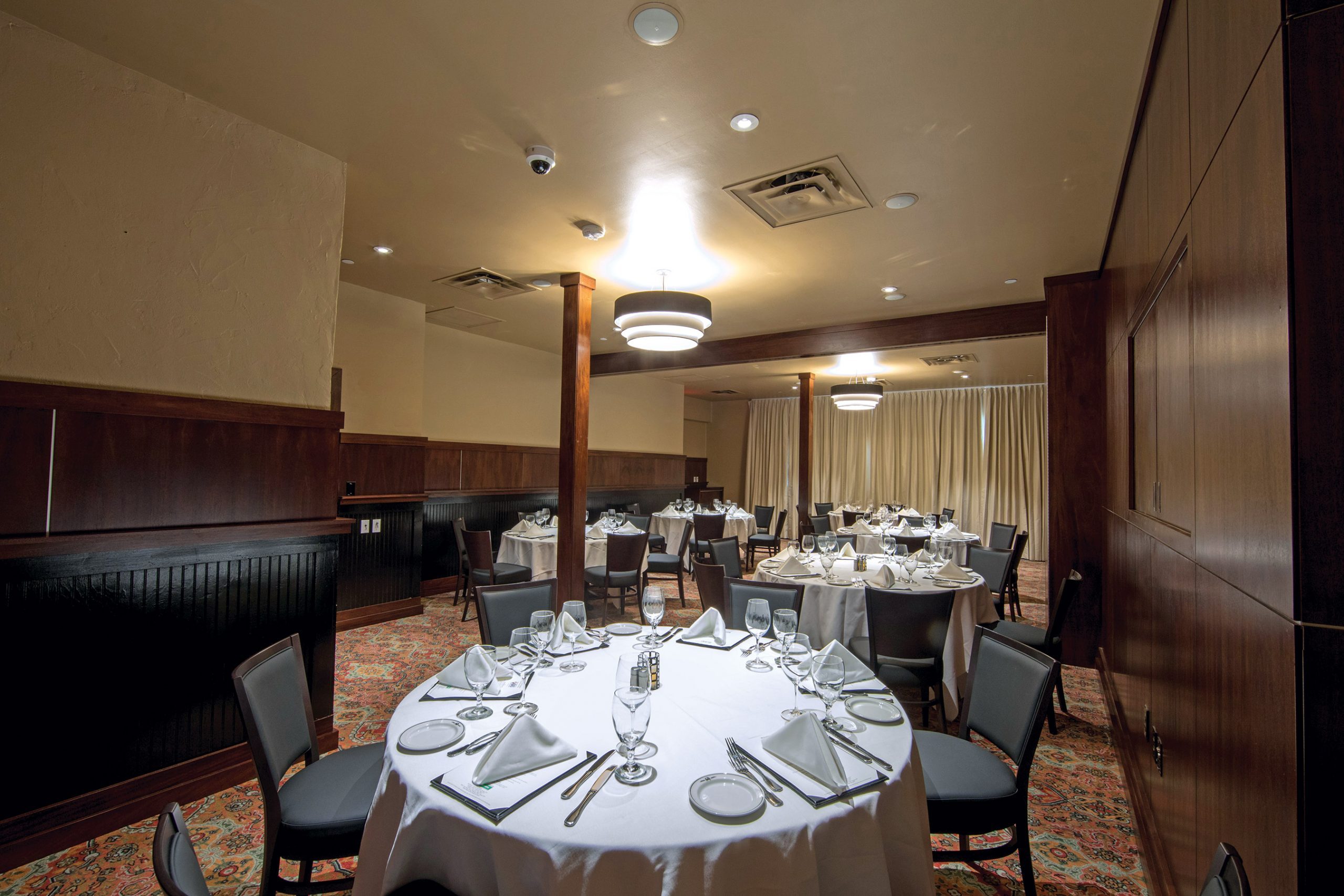 Truluck's Arboretum Capri room view from the NW corner of the room with 6 round tables with place settings