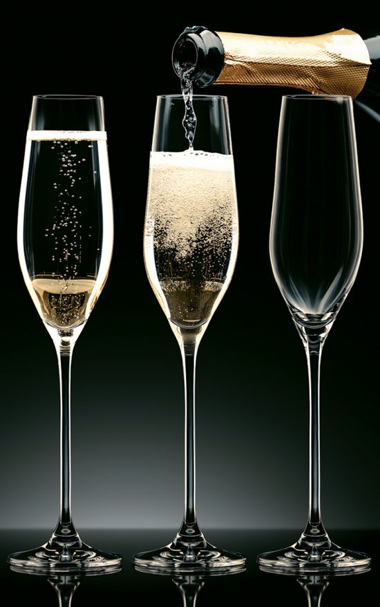 picture of Three champagne glasses being filled up