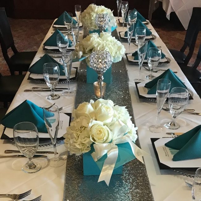 picture of Truluck's Woodlands private dining event featuring Tiffany blue napkins and Tiffany blue boxed centerpieces including white roses and white hydrangea flowers