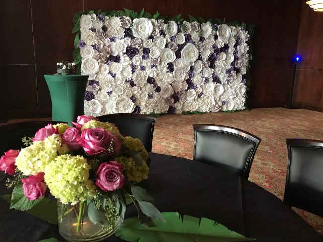 picture of Truluck's Woodlands private event with a 10' x 8' paper flower back drop. Each of these flowers is handmade and place on the board. This makes a wonderful photo back drop.