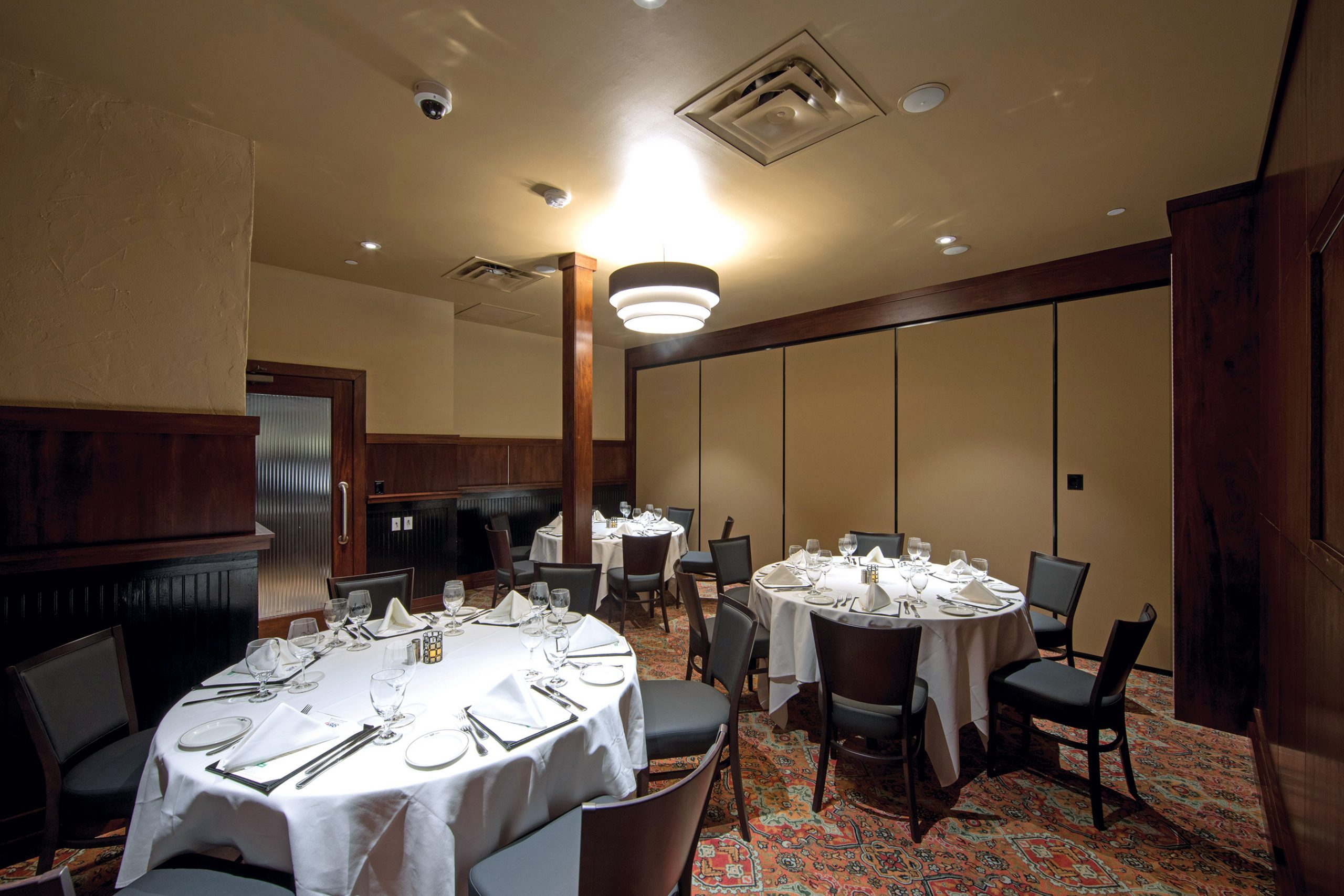 Austin Arboretum Pacific Room view from the NW corner of the room, 3 round tables with place settings