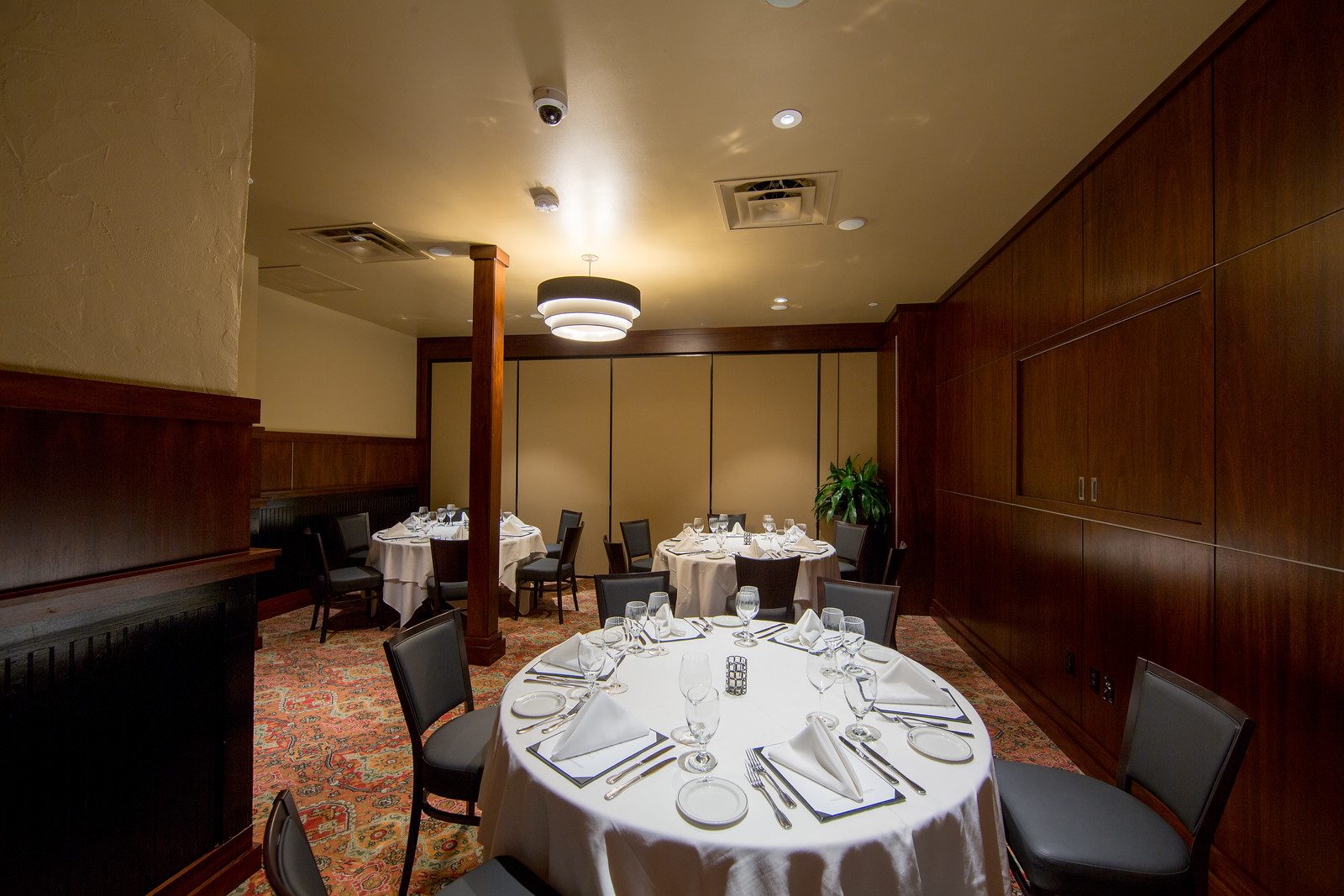 Austin Arboretum Pacific Room view from the NW corner of the room, 3 round tables with place settings