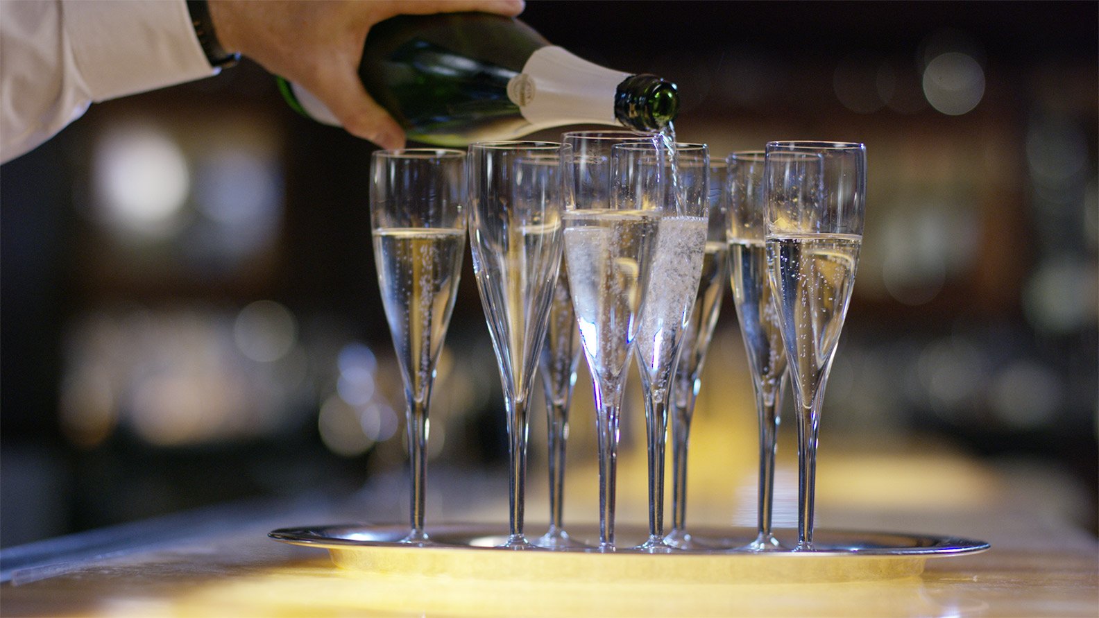 picture of Champagne glasses being filled for a celebration