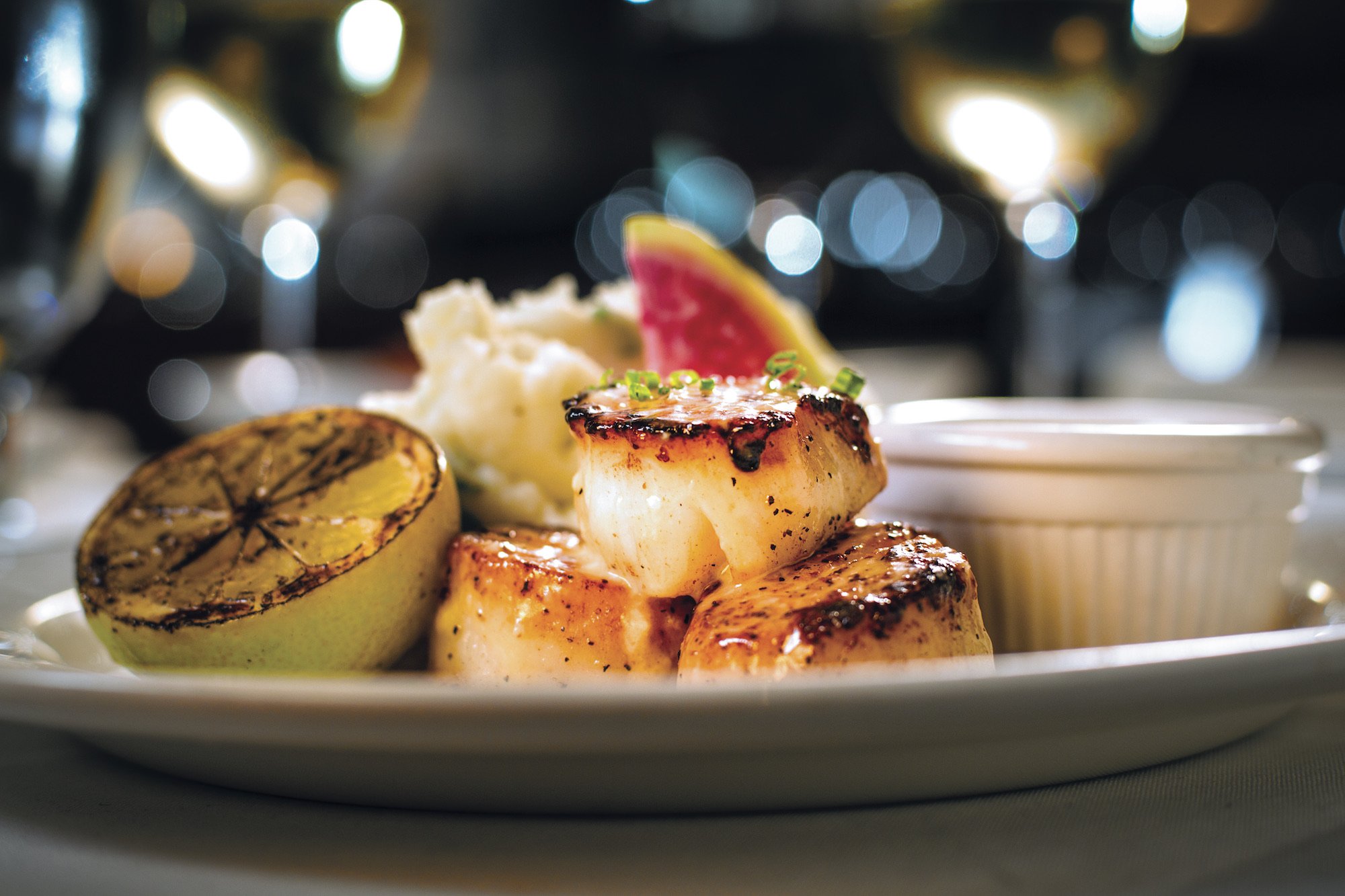 Pan-seared scallops, served with a fresh lemon and parmesan mashed potatoes