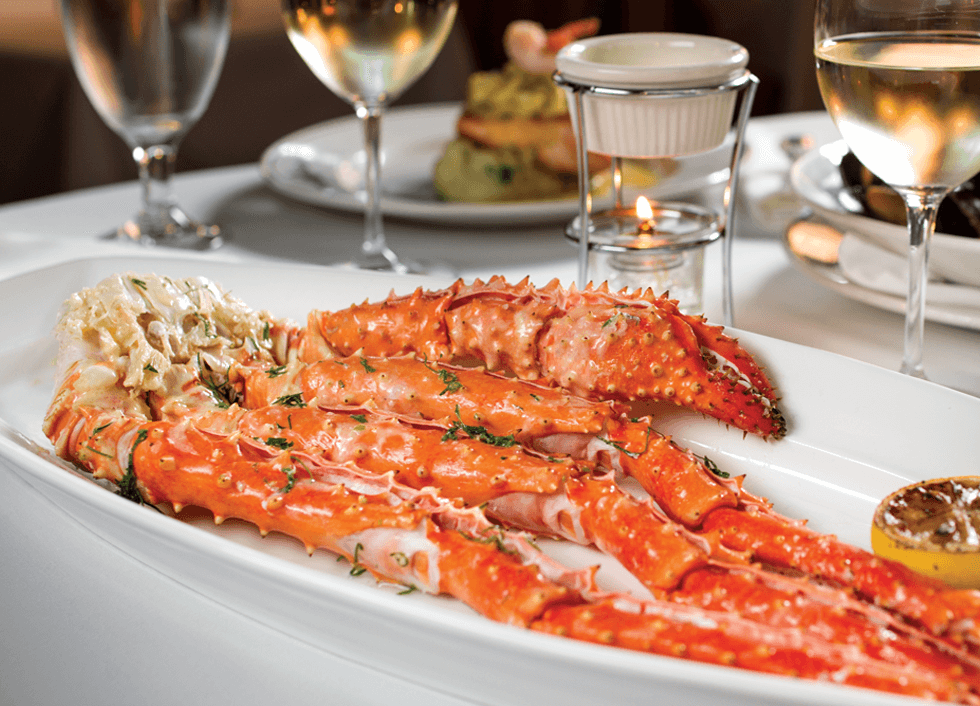 Fresh crab legs with fresh herbs on top