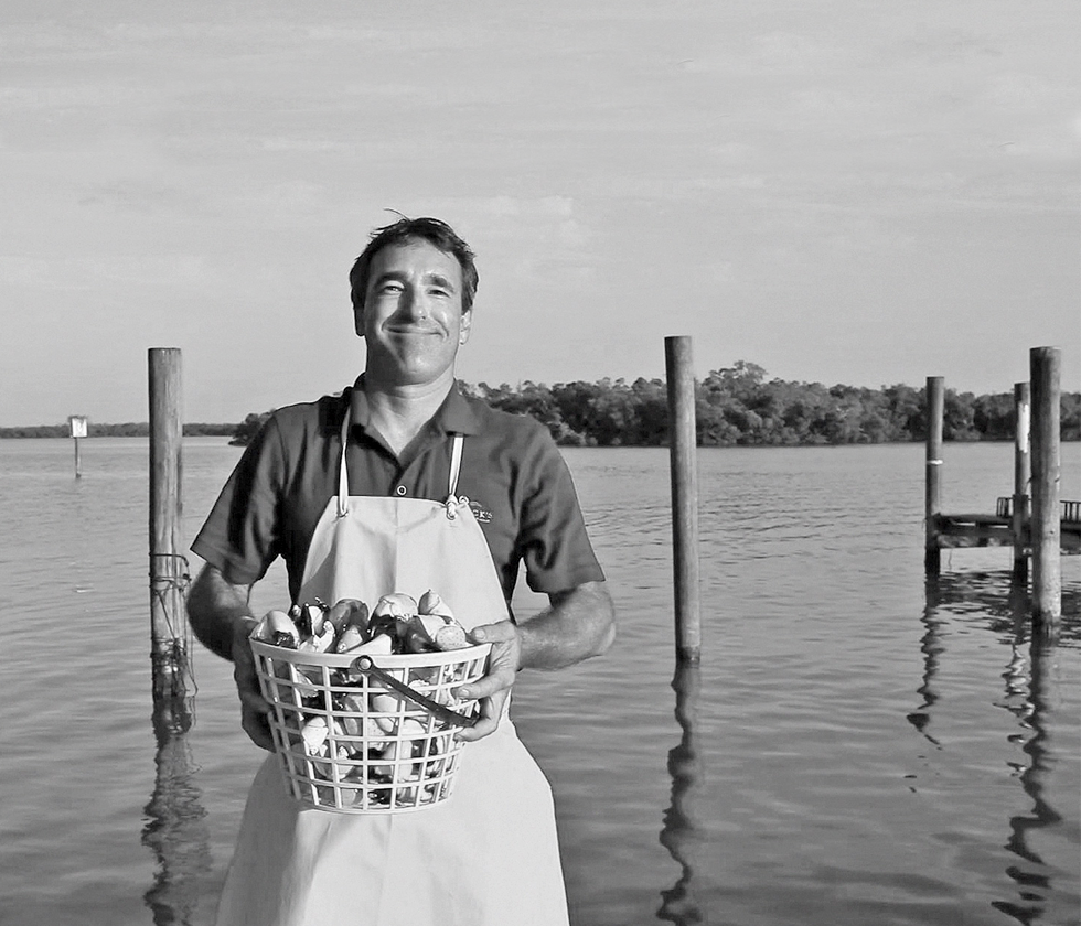 picture of A crabber proudly showing his basket of fresh catches