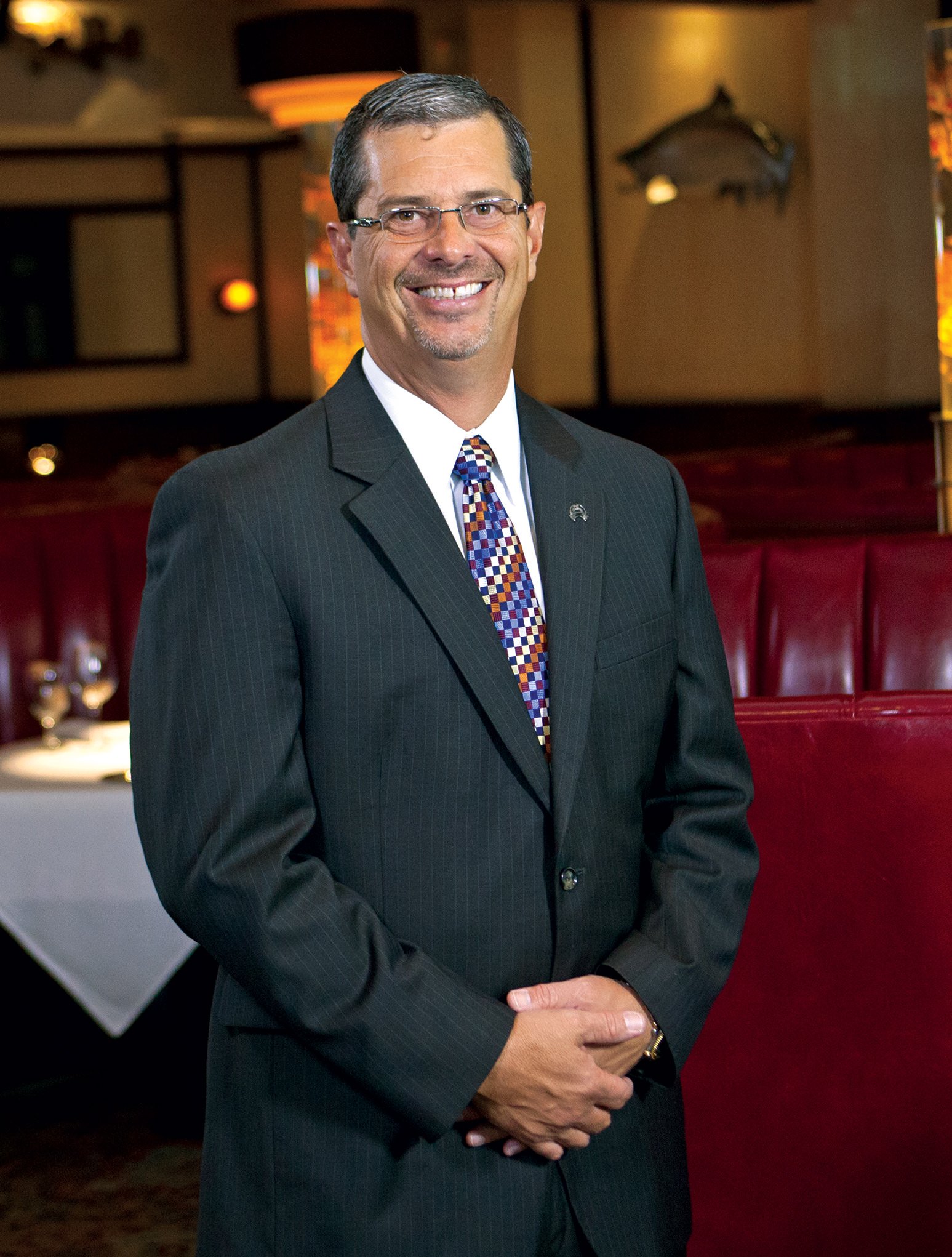 Picture of general manager, Mike McClure in the dining room in a suit and tie