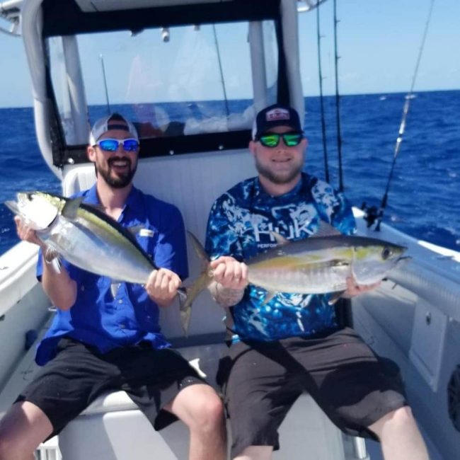 picture of Chris Davis and Chef Shane Flynn holding the fish they caught on a fishing trip