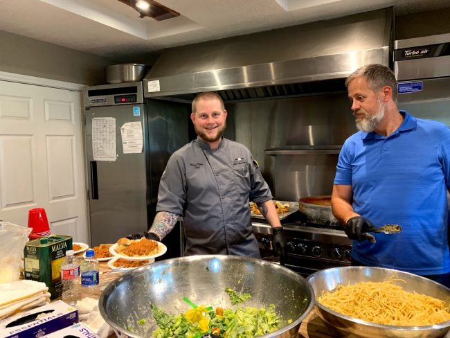 picture of Chef Shane Flynn at the children's shelter Yes to Youth where the Truluck's Woodlands team cooks dinner once a month.