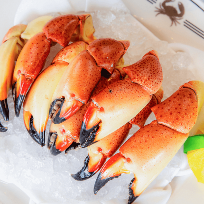 picture of Florida stone crab claws on a bed of ice with a wrapped lemon