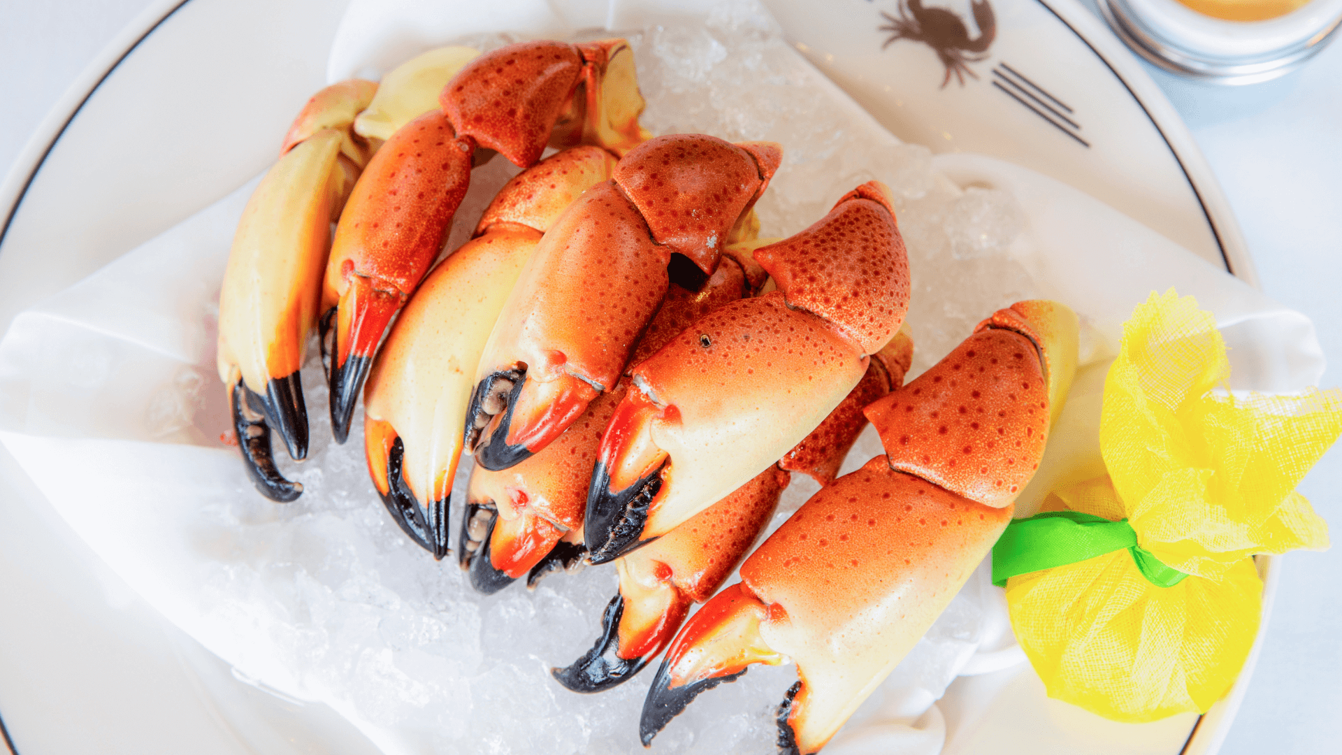 picture of Florida stone crab claws on a bed of ice with a wrapped lemon