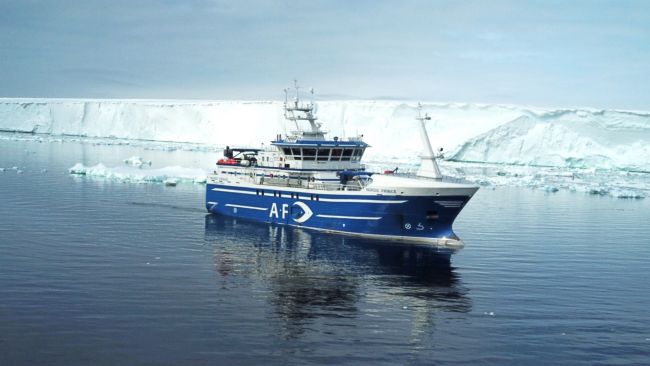 picture of fishing boat near iceberg