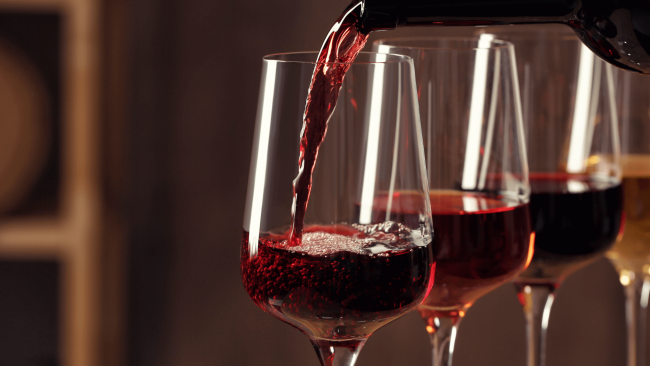 picture of red wine being poured into wine glasses