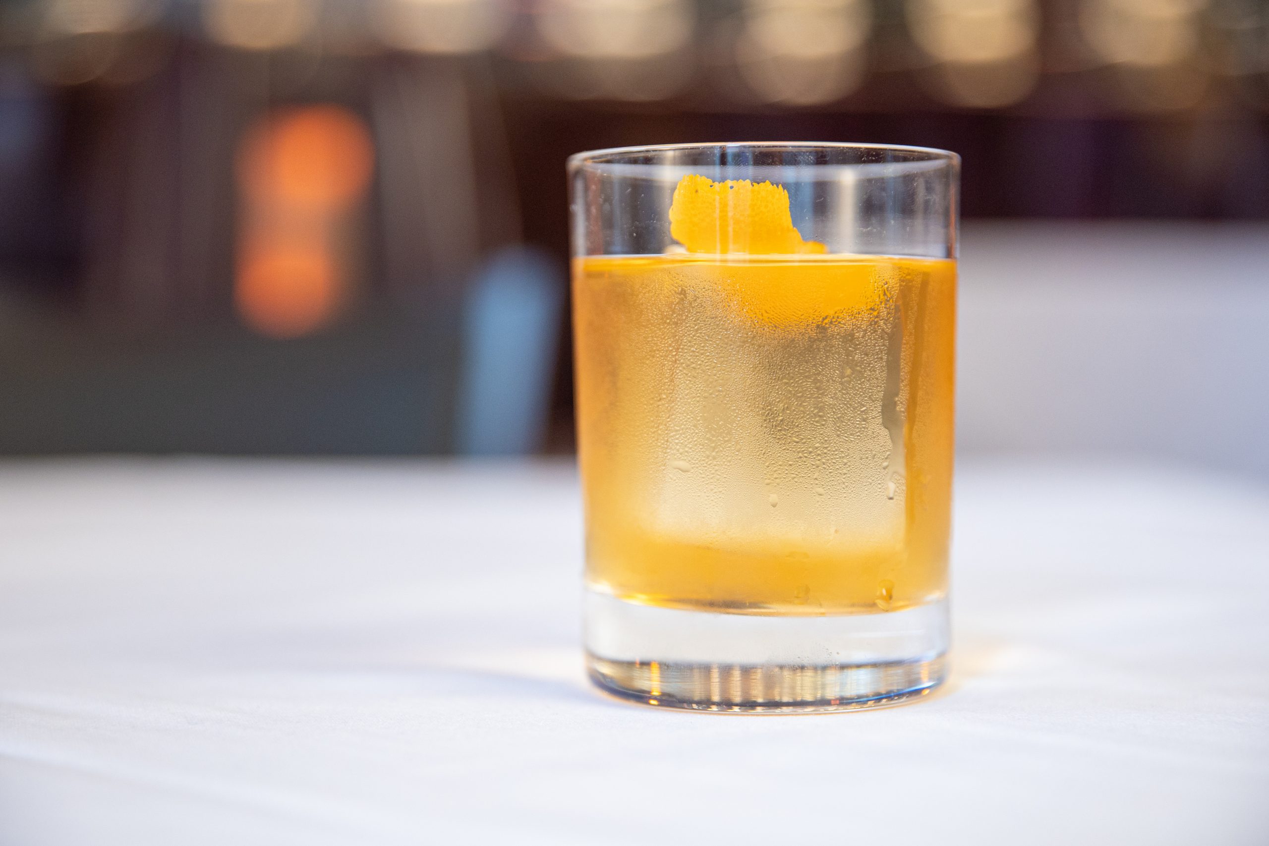 picture of the house old fashioned with an orange rind garnish