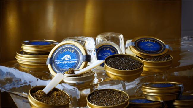 picture of Black River Caviar tins on ice with pearl spoons