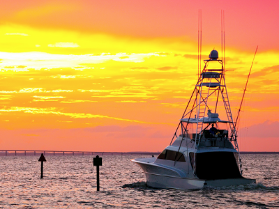 Fishing boat returning at sunset, representing Truluck's sustainable tuna sourcing partnerships