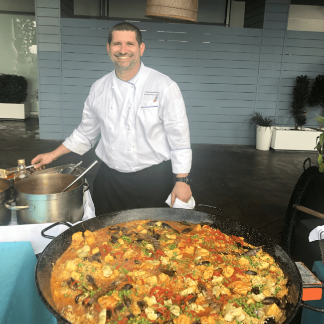 picture of Chef Odel with a giant pan of paella that he made