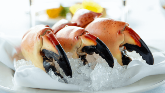 picture of 3 large Yucatan stone crab claws on a bed of ice