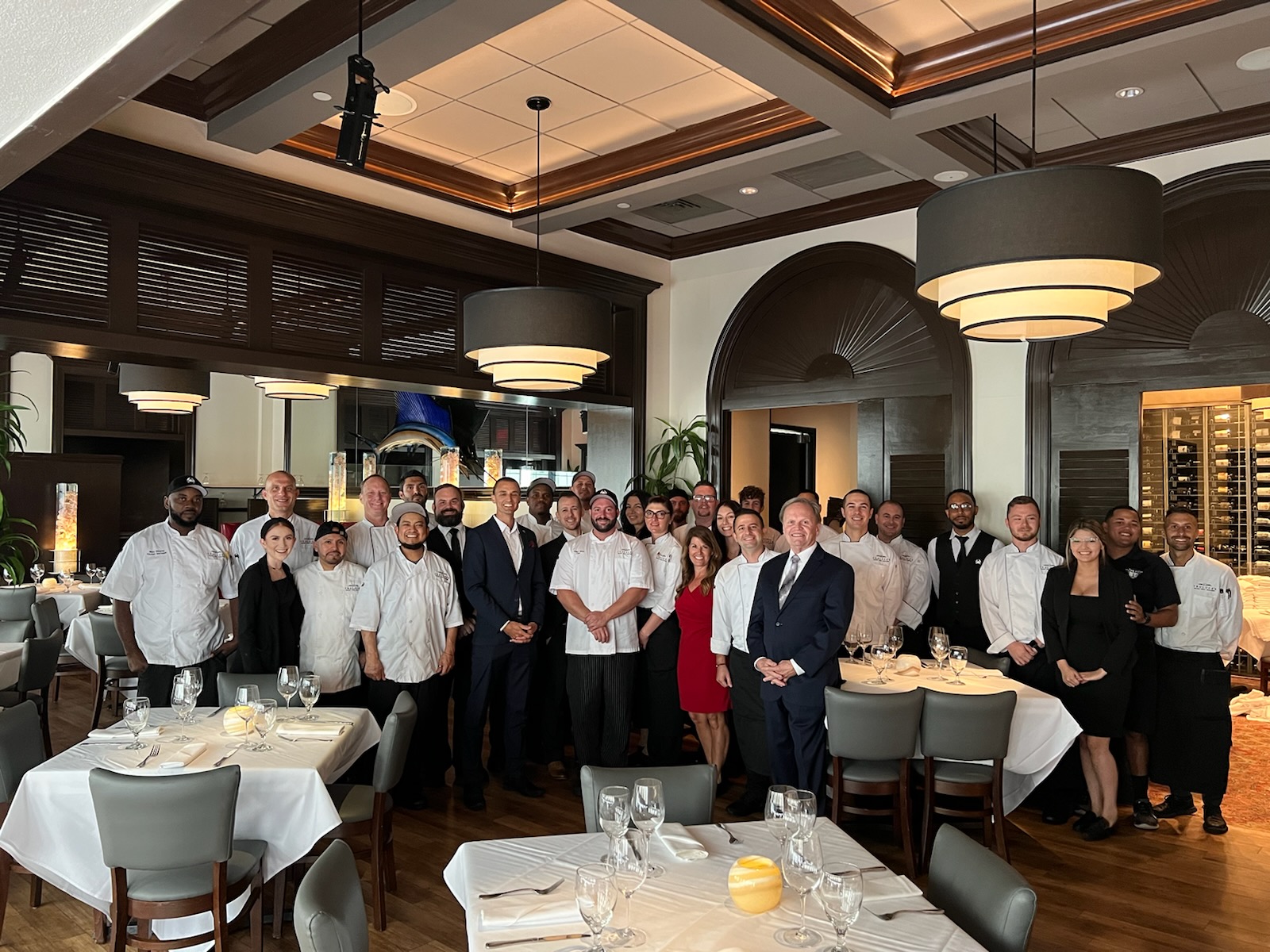 picture of the Naples staff gathered together in the main dining room for a group photo