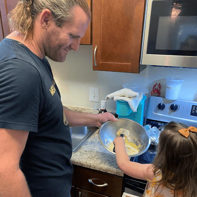 photo of Chef Travis and his daughter cooking together in the kitchen