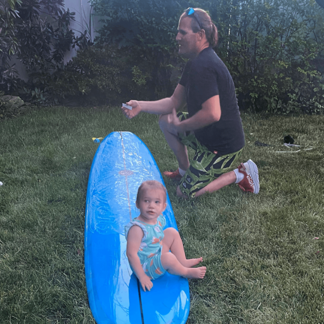 phot of Chef Travis with his daughter on a boogie board