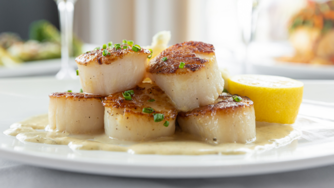 picture of Truluck's scallops with popcorn picatta sauce and a fresh lemon