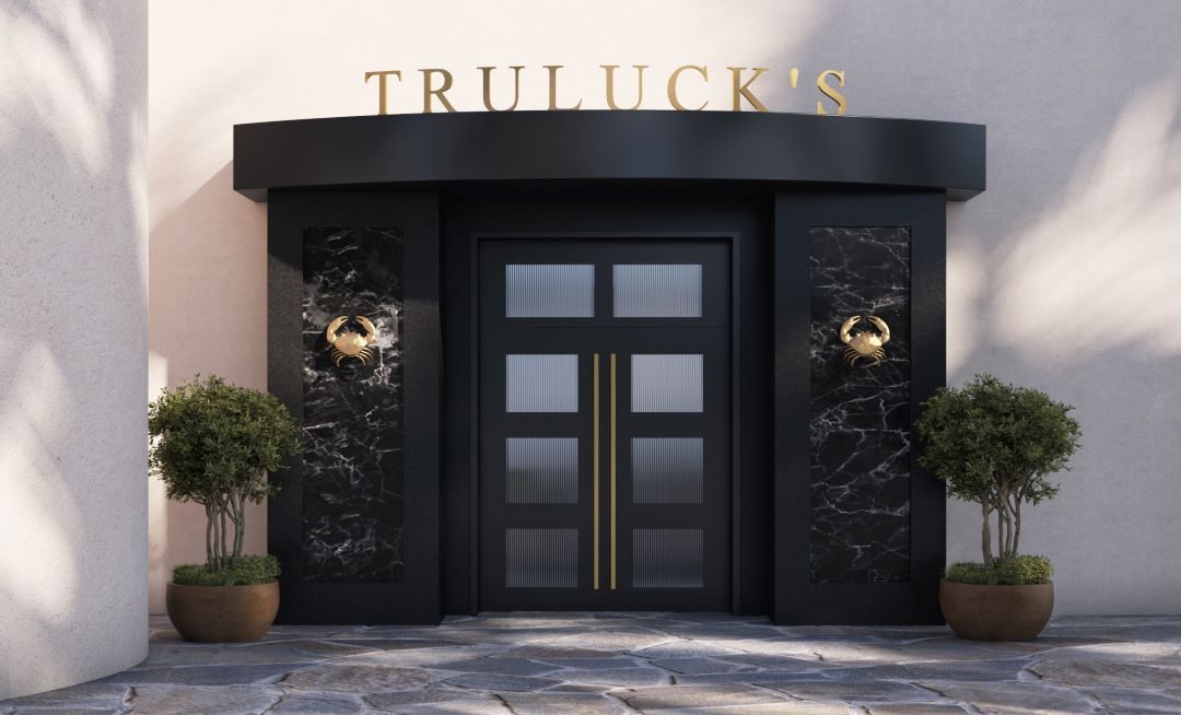 exterior front doors at Truluck's Fort Lauderdale with black doors and gold crab accents