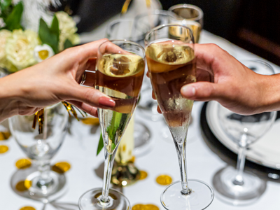 photo of two people toasting with champagne flutes