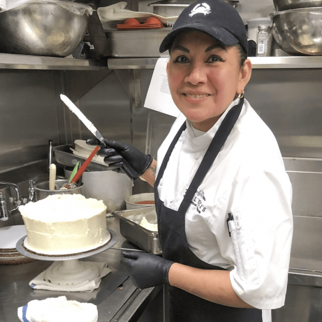 Paula is our Dallas pastry chef. She's icing a carrot cake in the kitchen.