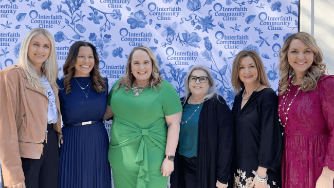 Truluck's home office team at a charity event posing at the step and repeat photo booth