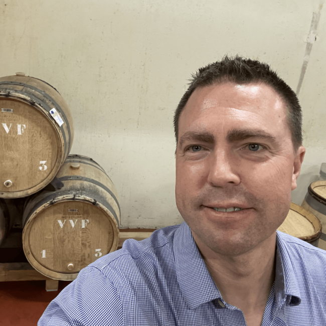 Selfie of Dave Mattern in front of Champagne Bollinger wooden wine casks