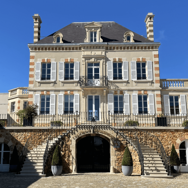 Champagne Bollinger winery three-story wine tasting house with double stair case leading to entrance