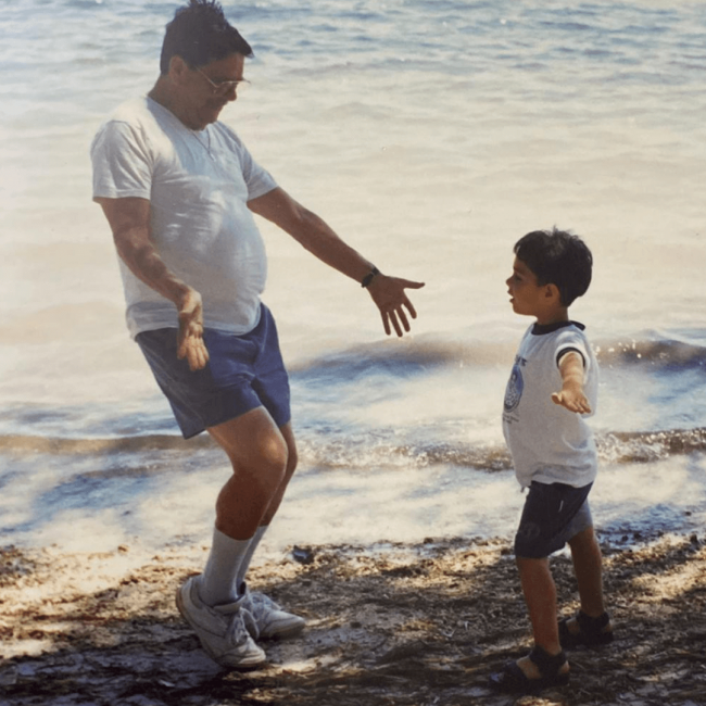 Chef Andrew Diaz as a young boy with his grandpa on the shoreline of the ocean