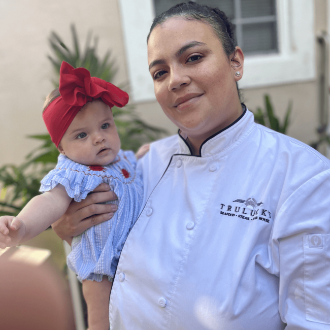 phot of Stephanie in her server jacket with her baby