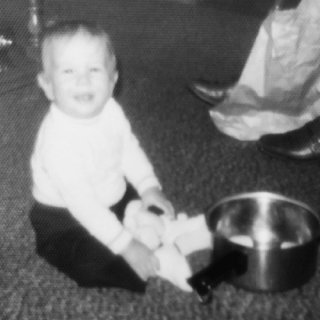 chef Thomas as a young toddler playing with a pot