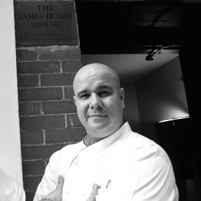 chef thomas in front of the James Beard House sign