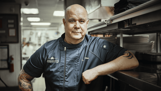 chef thomas with his elbow up on the kitchen line shelf