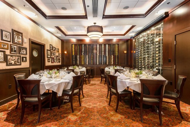 VIEW OF THE NAPLES ROOM FROM THE DOORWAY WITH TABLES SETUP AS ROUND TABLES