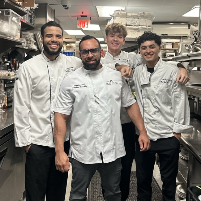 Chef Estphan with a few of the server team member in the back of house kitchen area
