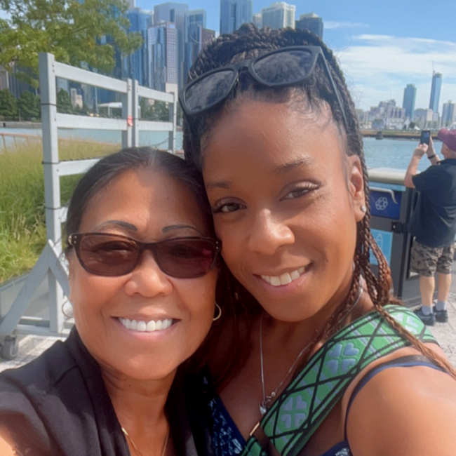 Darsha and her mom smiling with the Chicago skyline in the background