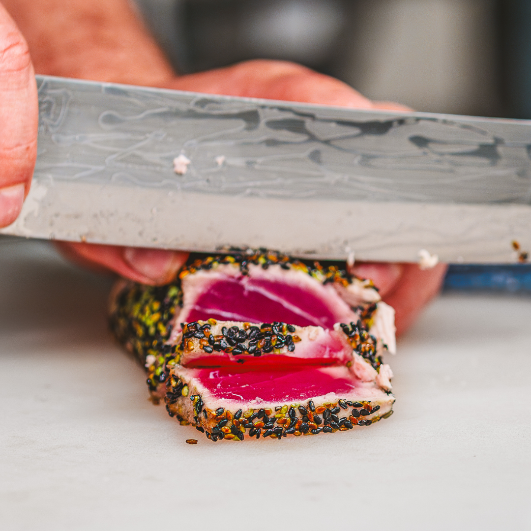 Truluck's chef slicing freshly prepared sesame seared ahi tuna