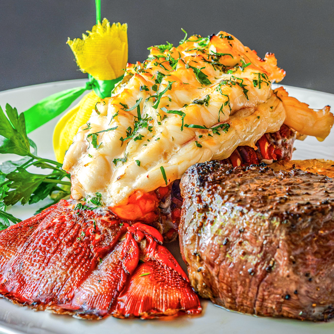 South African lobster tail dressed in butter and chives with a peppered filet mignon, dressed with a wrapped lemon and parsley