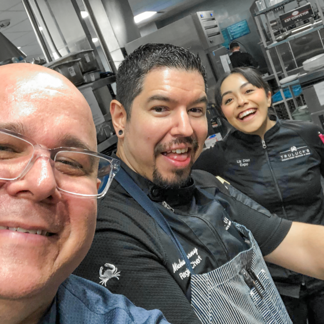 Chef Mike with Chef Thomas and the expo Liz in the back of house kitchen