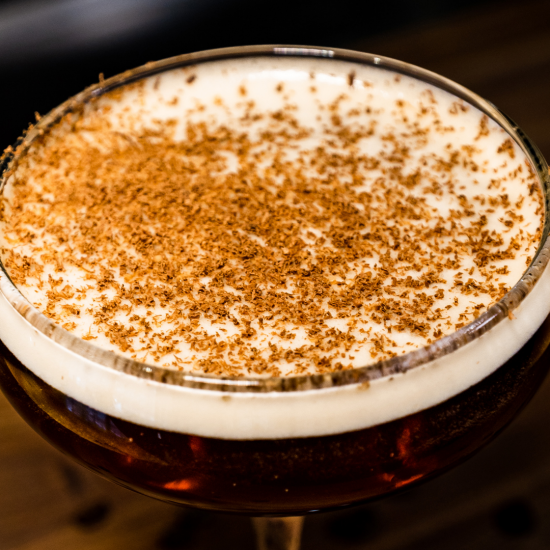 An overhead shot of an espresso martini with chocolate shavings on top