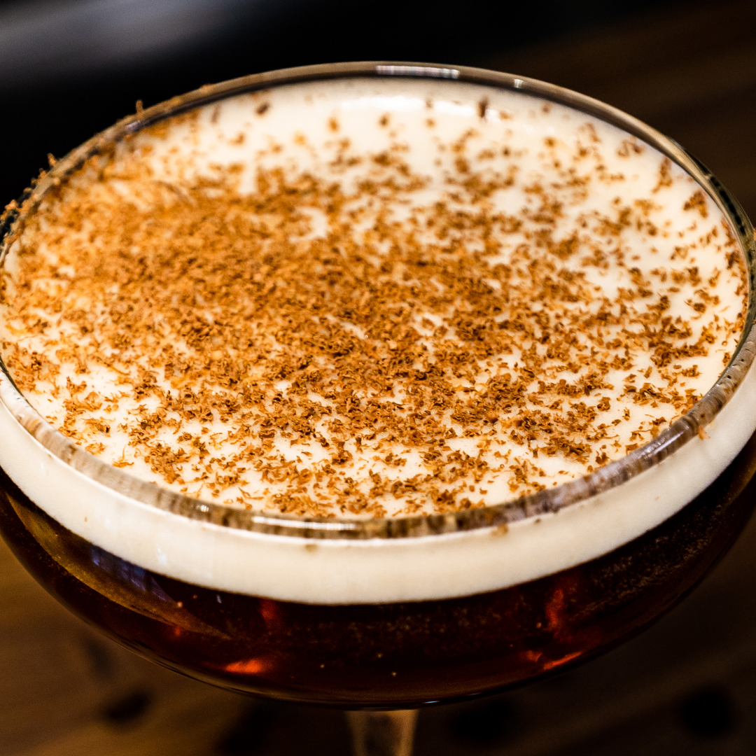 An overhead shot of an espresso martini with chocolate shavings on top