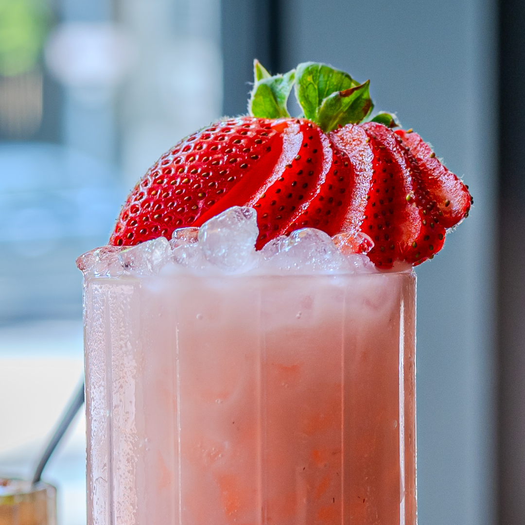 Zero proof mocktail with artfully fanned strawberry garnish, premium alcohol free beverage for Dry January