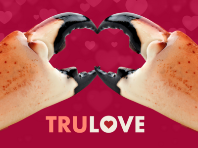 2 Stone crab claws put together to make a heart shape with the claws with TRULOVE in all caps below them